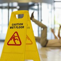 Businessman slipping on wet office floor